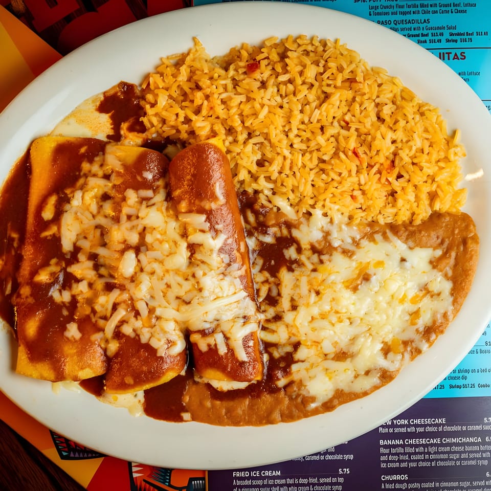El Paso Mexican Grill's enchiladas with red sauce and melted cheese, served with rice and refried beans.